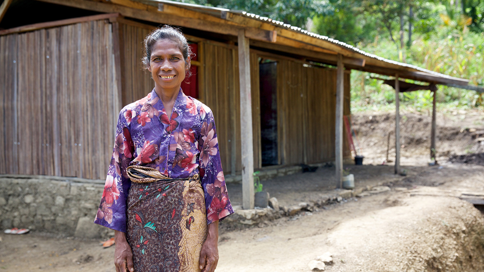 Martina Standing In Front Of Her Home