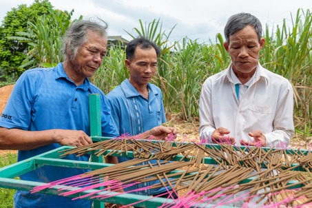 Thu Making Incence With His VSLA Members