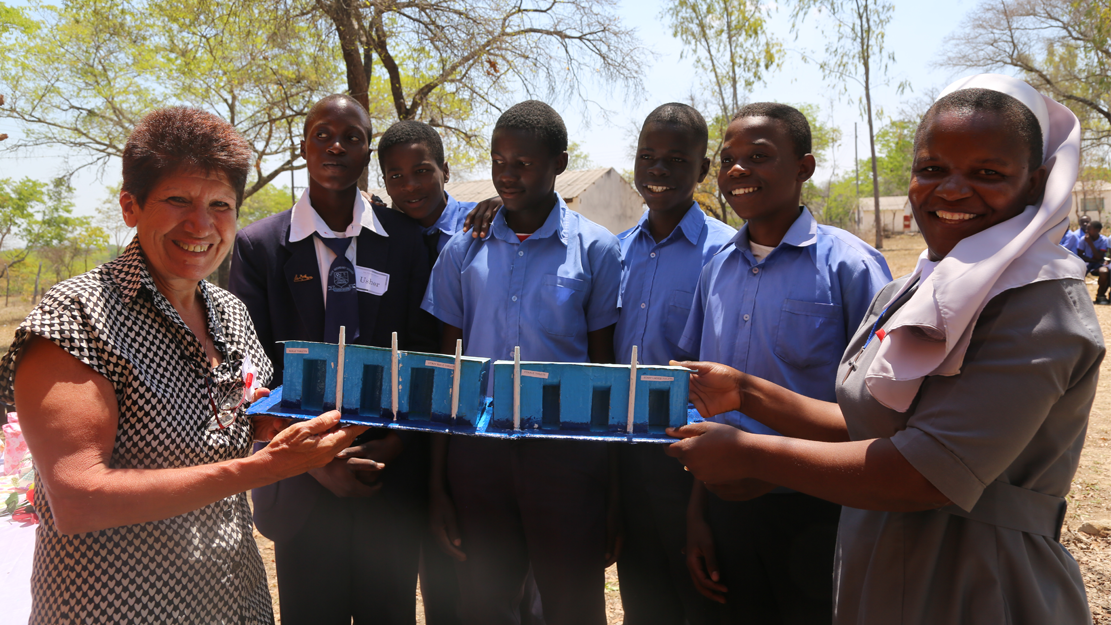 Employee helping group of school students