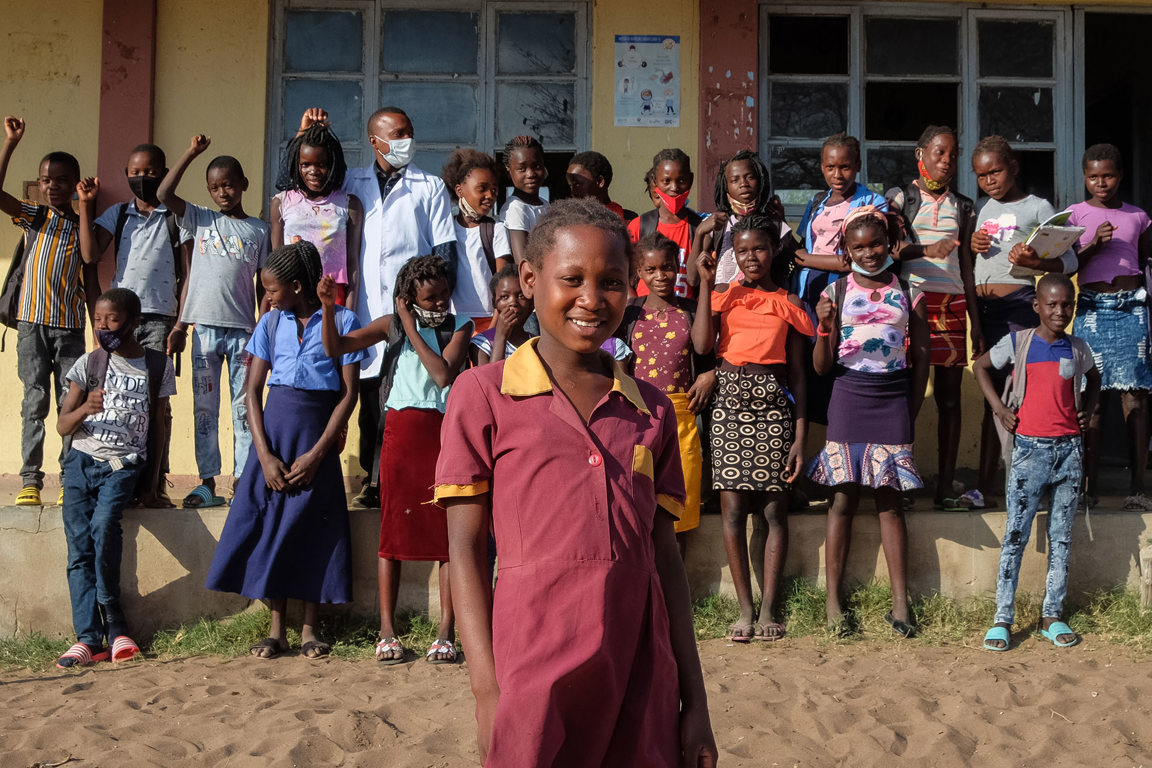 Anatercia with other students in front of her local school in her village in Mozambique