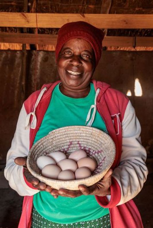 Priscilla Holding Basket Of Eggs