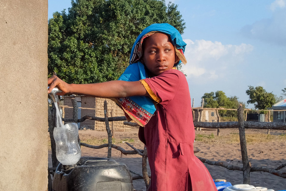 Anatercia collects water from the community water tap near her house in Mozambique