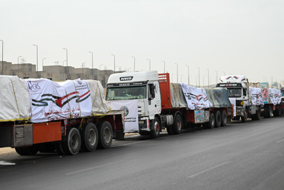 A queue of Caritas Australia's partner trucks containing blankets, mats and mattresses bound for Gaza. Photo Credit: Sayed Hassan for CRS.