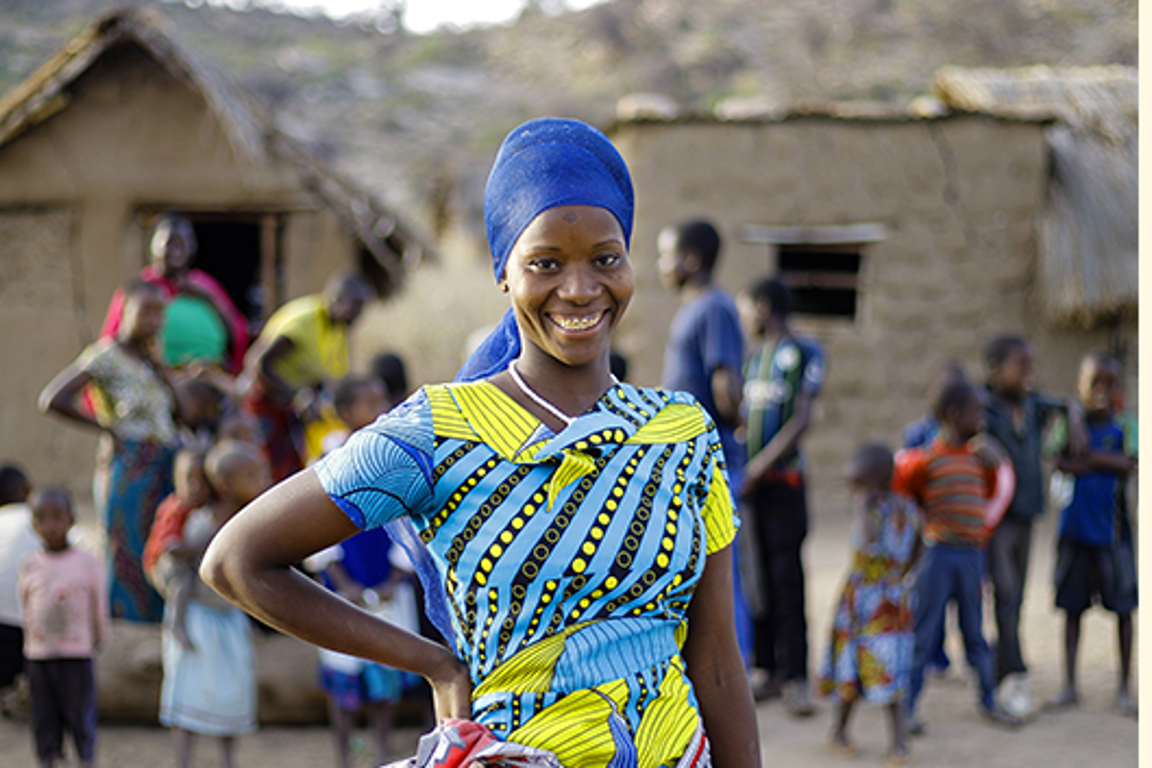 Oliva stands near her home in Karatu District, Tanzania