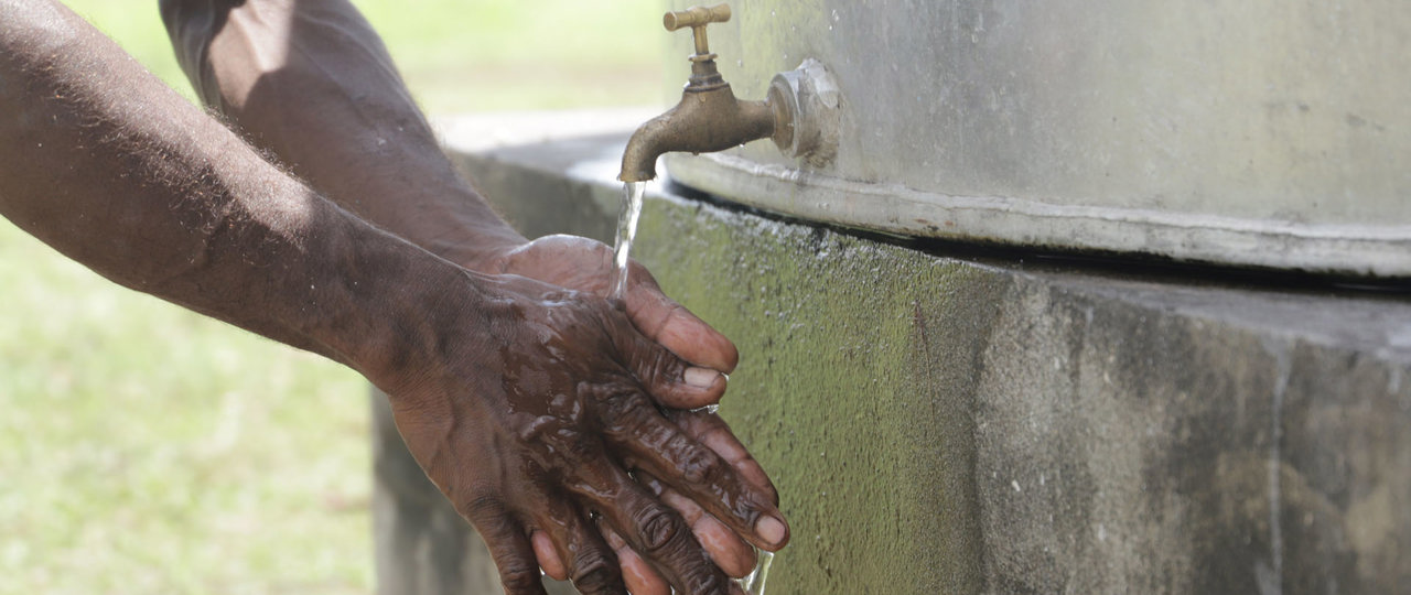 Washing Hands Using A New Water Tank In The Solomons