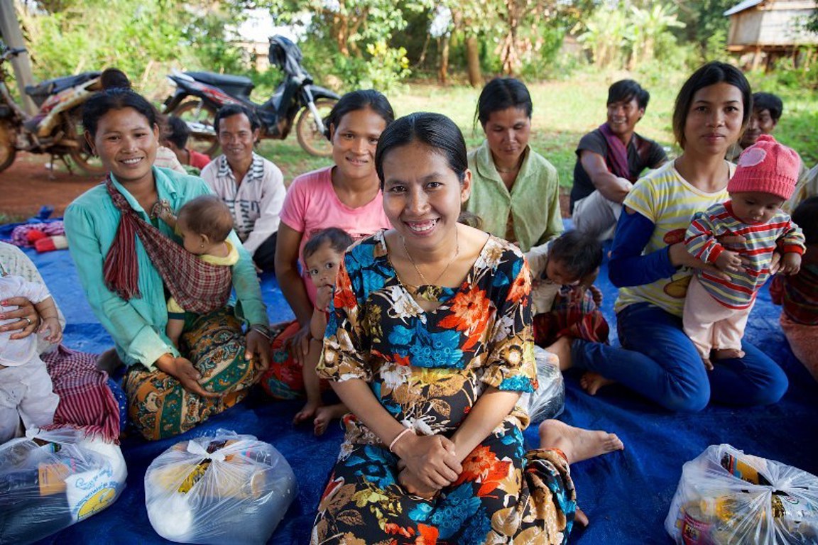 Women and children receive food donations in Cambodia