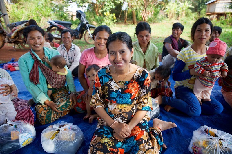 Women and children receive food donations in Cambodia
