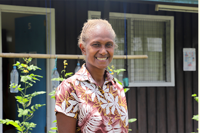 Margret standing outside a classroom in the Solomon Islands