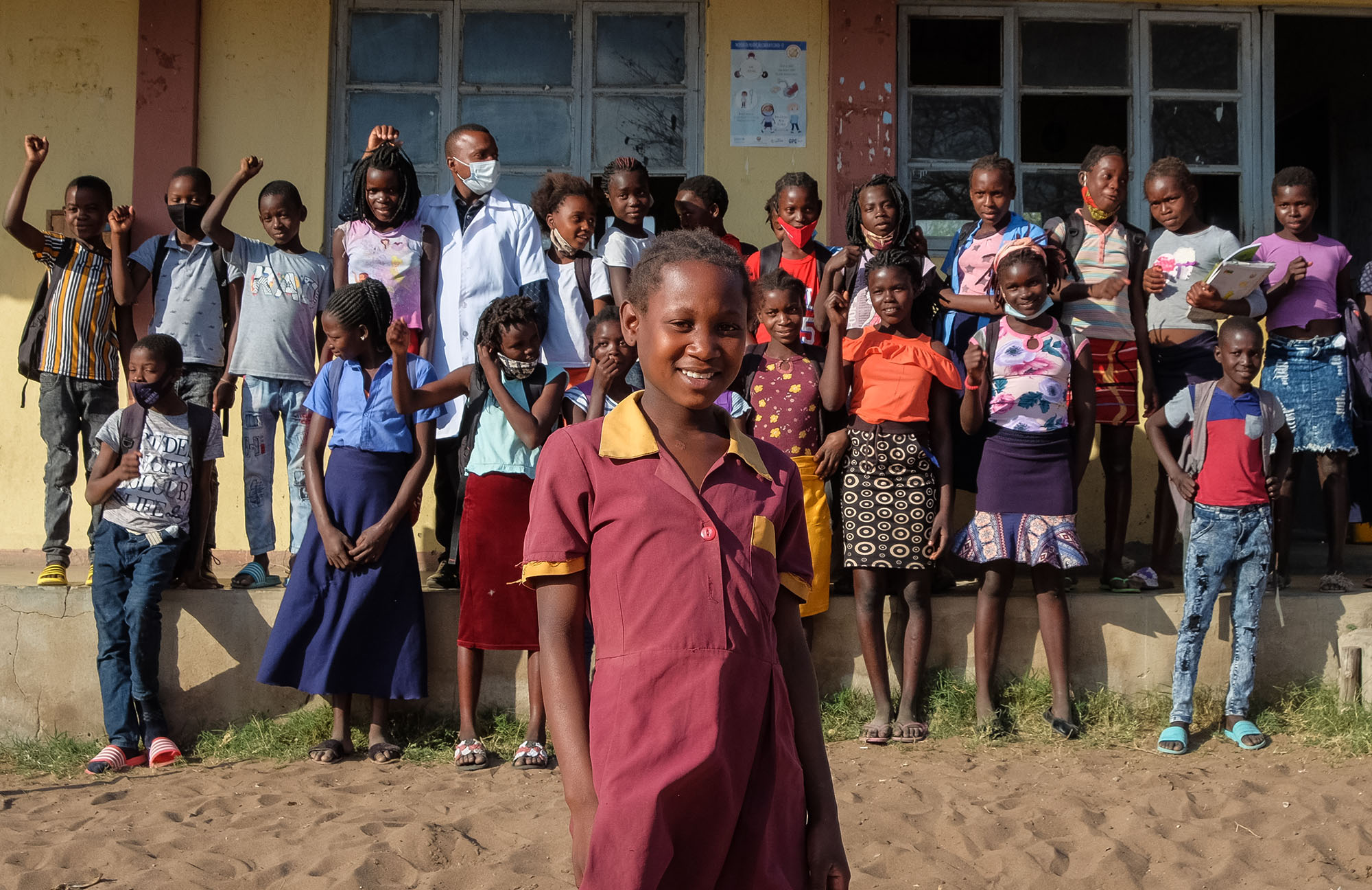 Anatercia with other students in front of her local school in her village in Mozambique