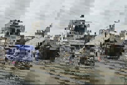 People Cycle Past Destroyed Buildings In Gaza Photo Credit CRS