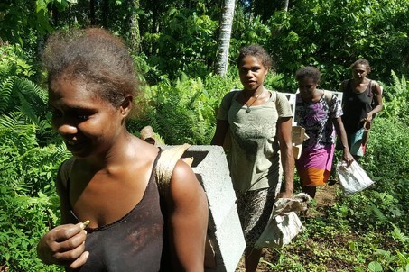 Women carrying bricks in Solomon Islands