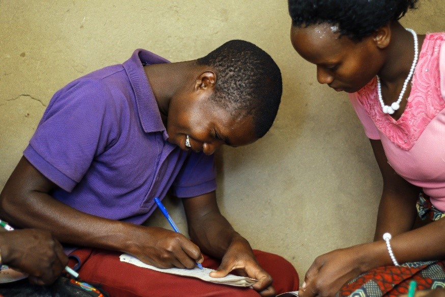 Boy Writing With Woman
